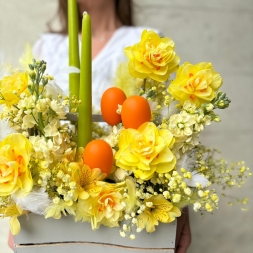 Easter composition with yellow flowers and candles