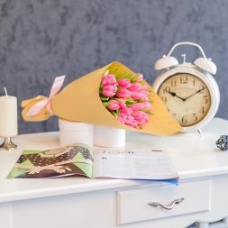 Bouquet of pink tulips in natural paper