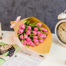 Bouquet of pink tulips in natural paper