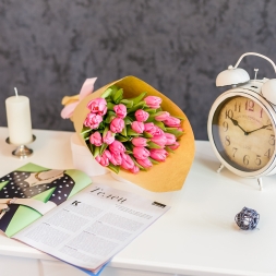 Bouquet of pink tulips in natural paper